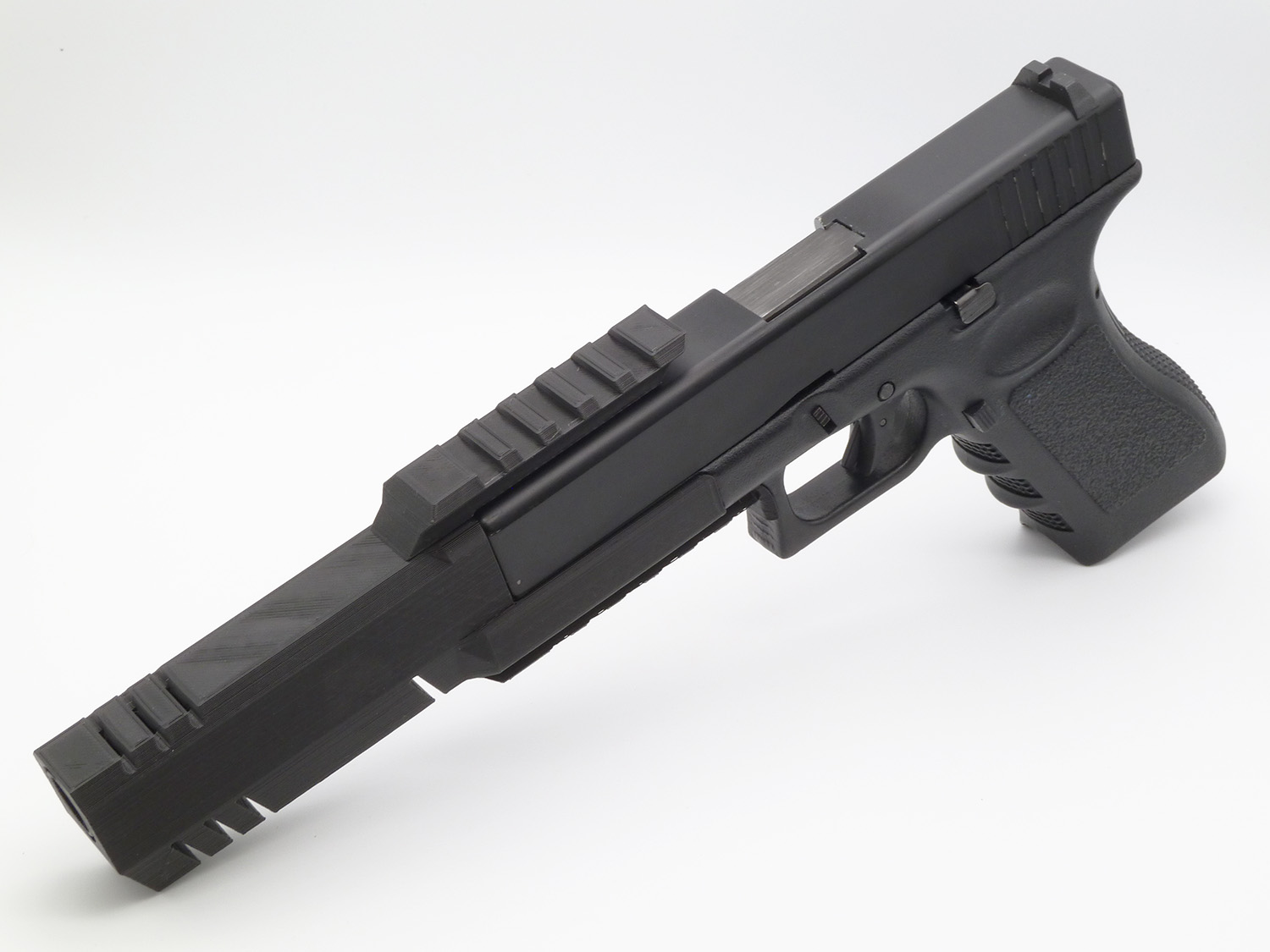 Long muzzle break with top rail, attached to an ASG Glock 17 (Glock not included!)