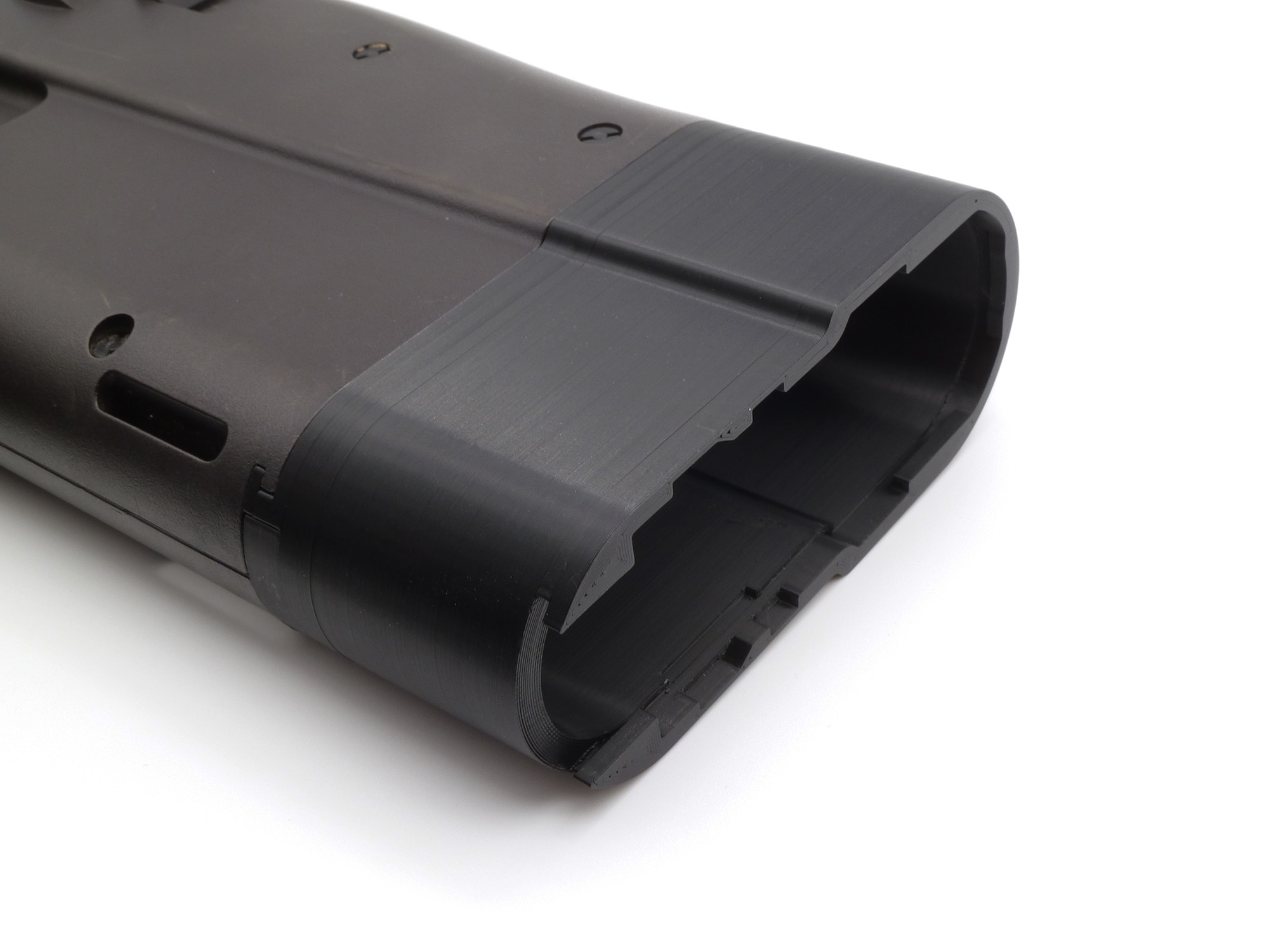 Attached to a Tokyo Marui P90, buttstock cap removed