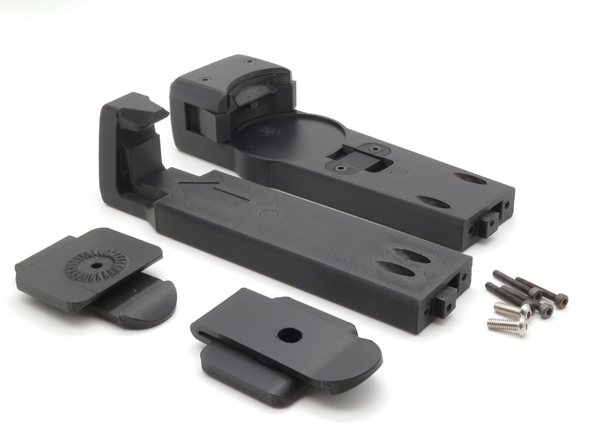 The individual parts of the kit, including the 2 main body parts, 2 adapters, and 6 screws